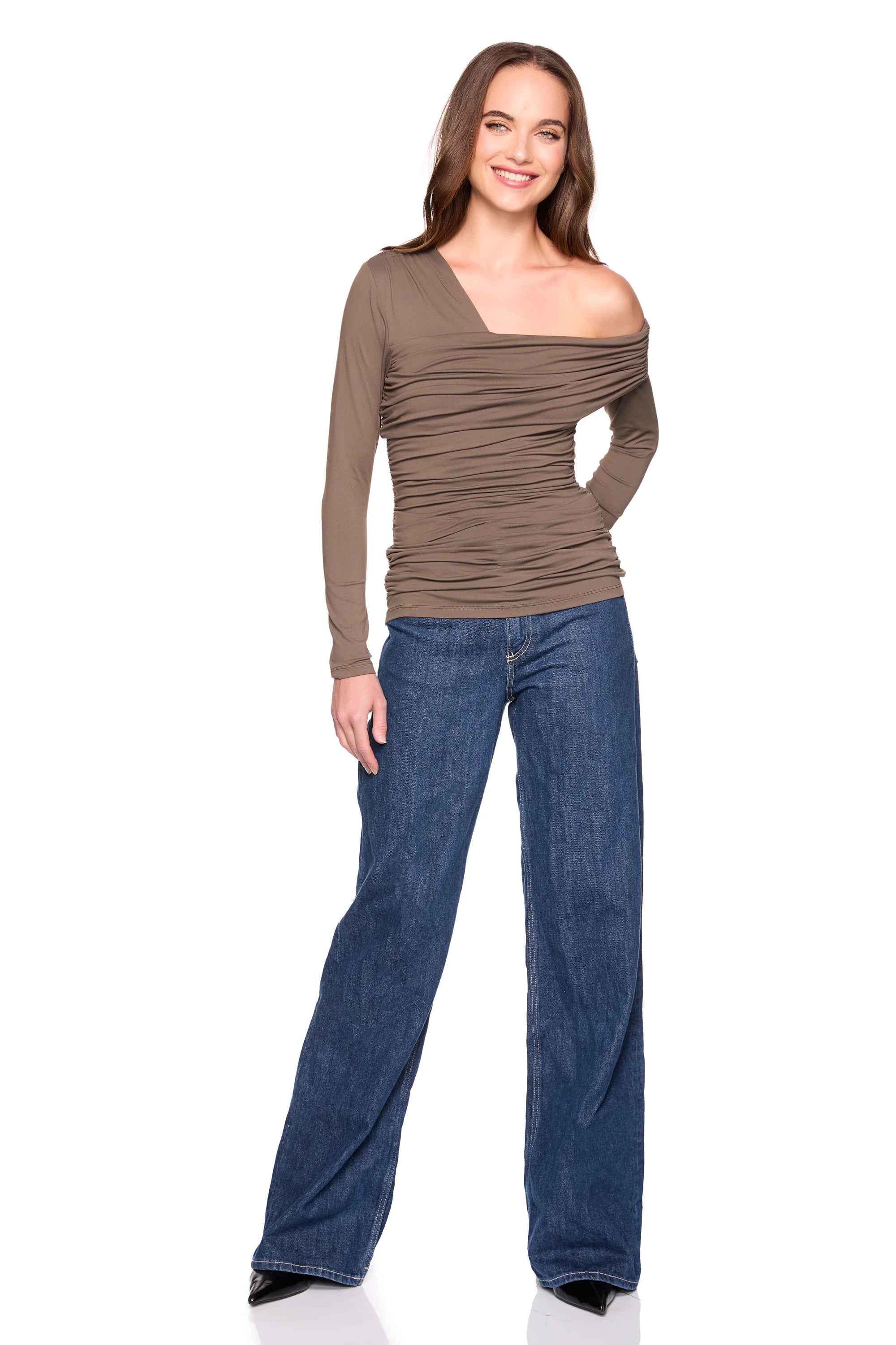 Woman wearing a brown off-shoulder top and blue jeans on a white background, full body front