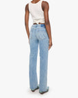 Woman wearing light blue jeans and a white sleeveless top on a white background