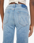 Light blue jeans worn by a person on a white background