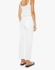 Woman wearing a white sleeveless top and pants on a white background