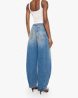 A model shown from the back wearing wide-leg blue denim jeans with a faded wash, a white tank top, and brown pointed-toe heels against a plain white studio background.
