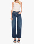 Woman wearing blue jeans and a white top on a white background