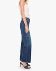 Woman wearing blue jeans and a white top on a white background