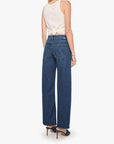 Woman wearing blue jeans and a white top on a white background