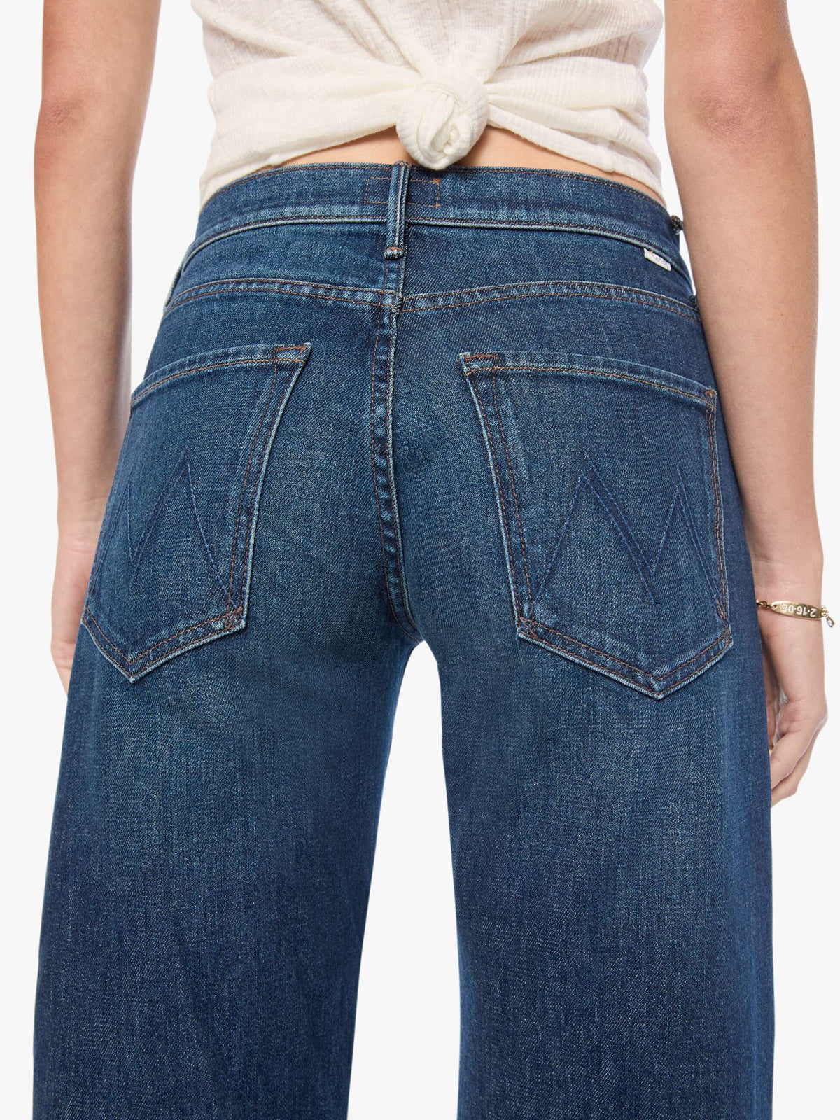 Blue jeans worn by a person on a white background
