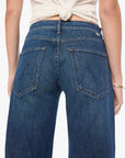 Blue jeans worn by a person on a white background
