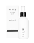 White spray bottle labeled 'milky' on a white background
