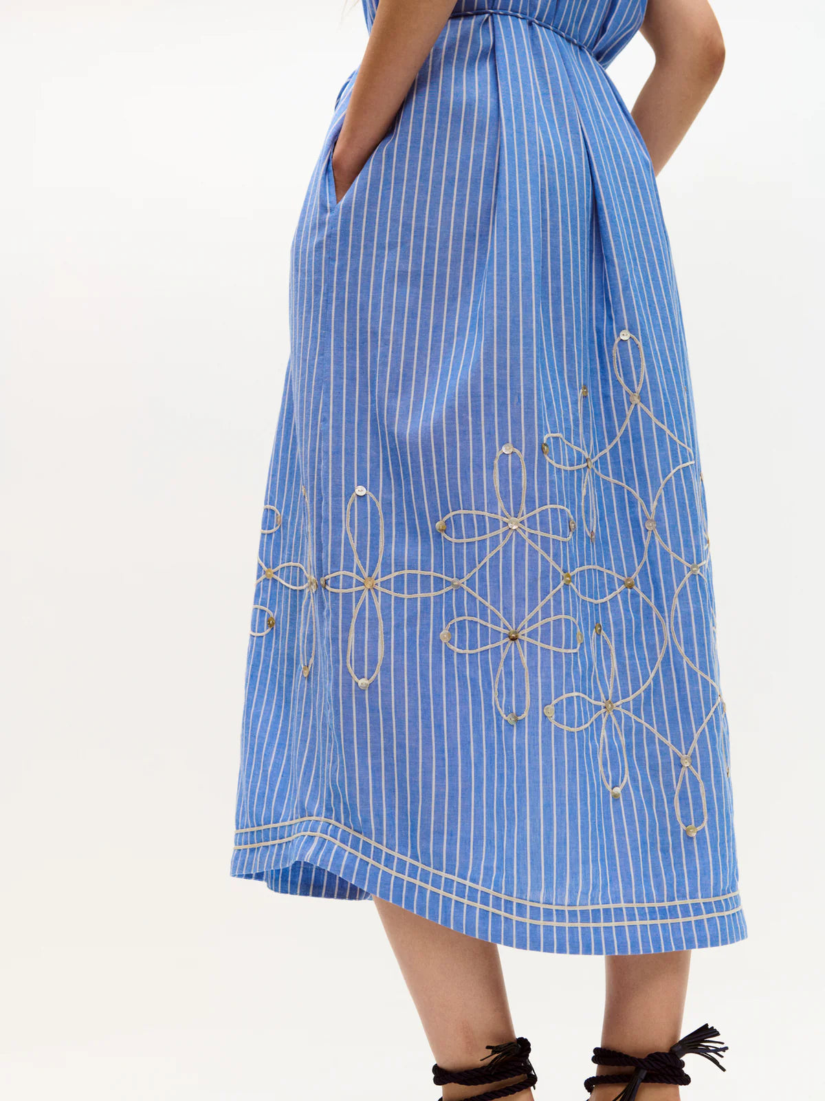 Blue striped dress with floral embroidery on a white background