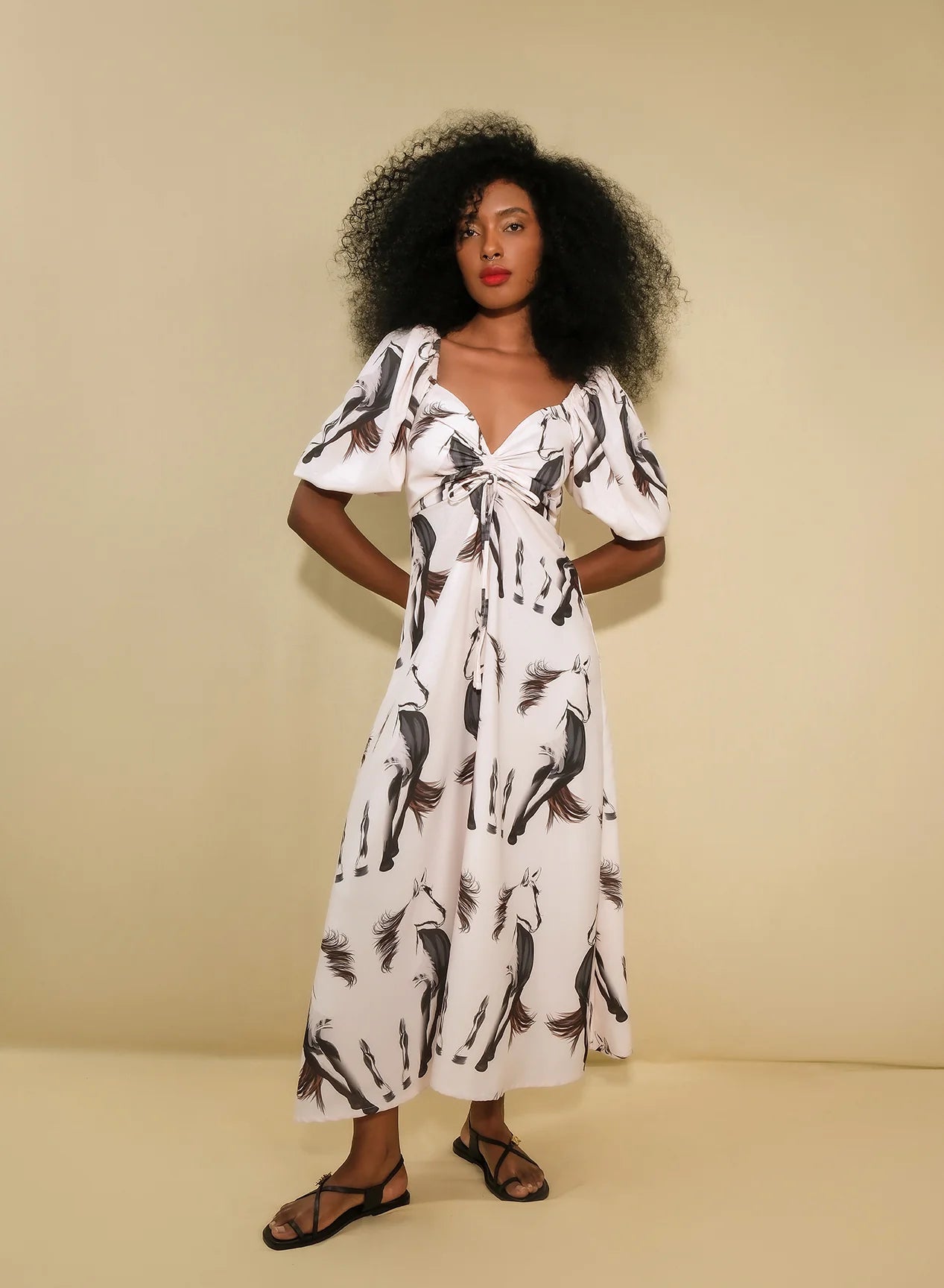 The Sol dress on a model on a beige background front view 