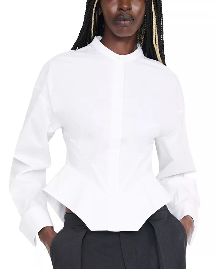 A model wearing a white long-sleeve blouse with a structured, slightly cropped peplum-style hem and a stand collar, paired with dark gray trousers against a plain white background.