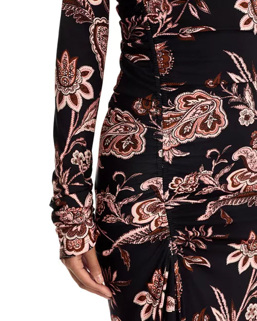 Close-up of a long-sleeve ruched dress with a black base and an intricate paisley and floral pattern in dusty pink, brown, and white, featuring a gathered side detail.