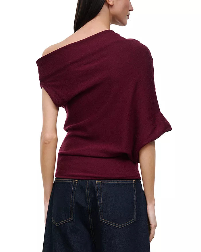 model wearing off shoulder pinot sweater with jeans on a white background, back 