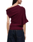 model wearing off shoulder pinot sweater with jeans on a white background, back 