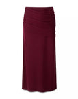 A draped midi skirt in deep burgundy, featuring a gathered waistband and flowing, asymmetrical folds, shown against a plain white background.