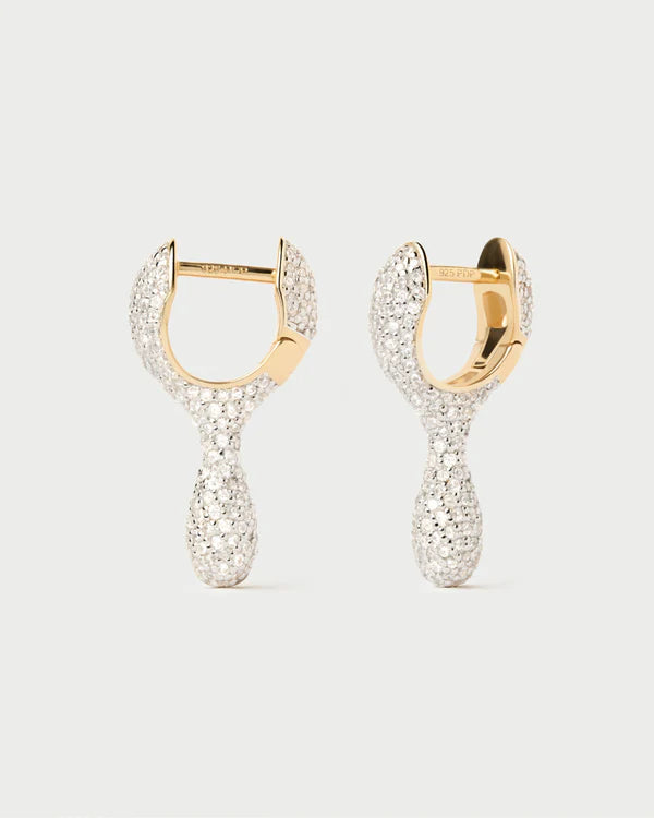 Gold hoop earrings with diamond-like stones on a light gray background