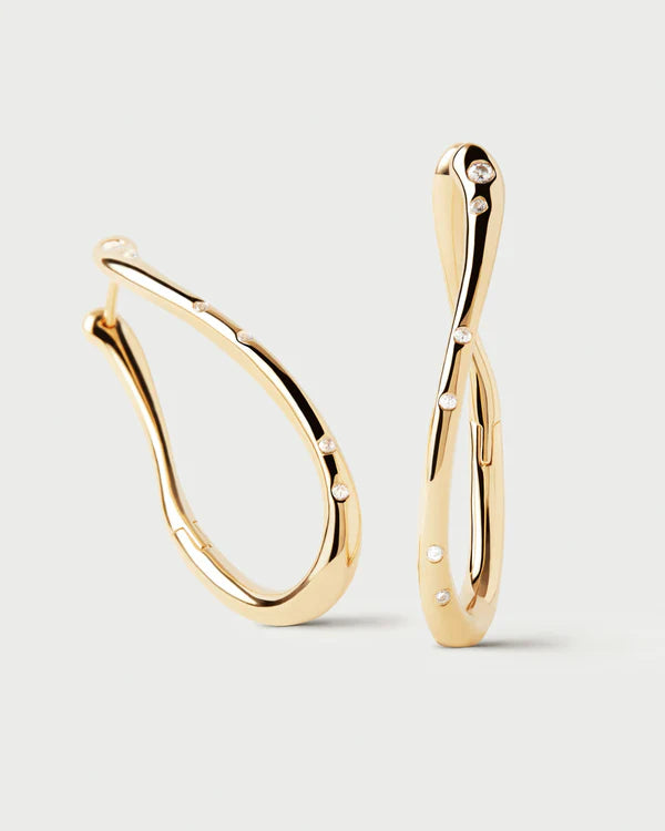Gold hoop earrings on a light gray background