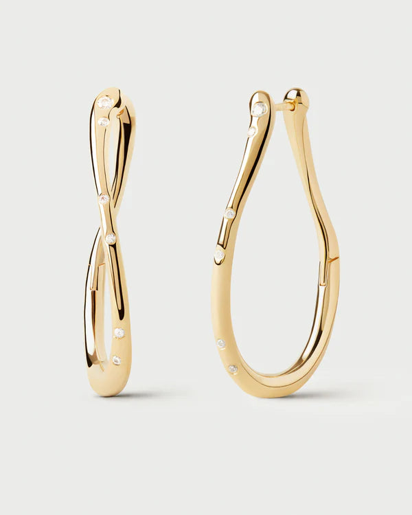 Gold hoop earrings on a light gray background