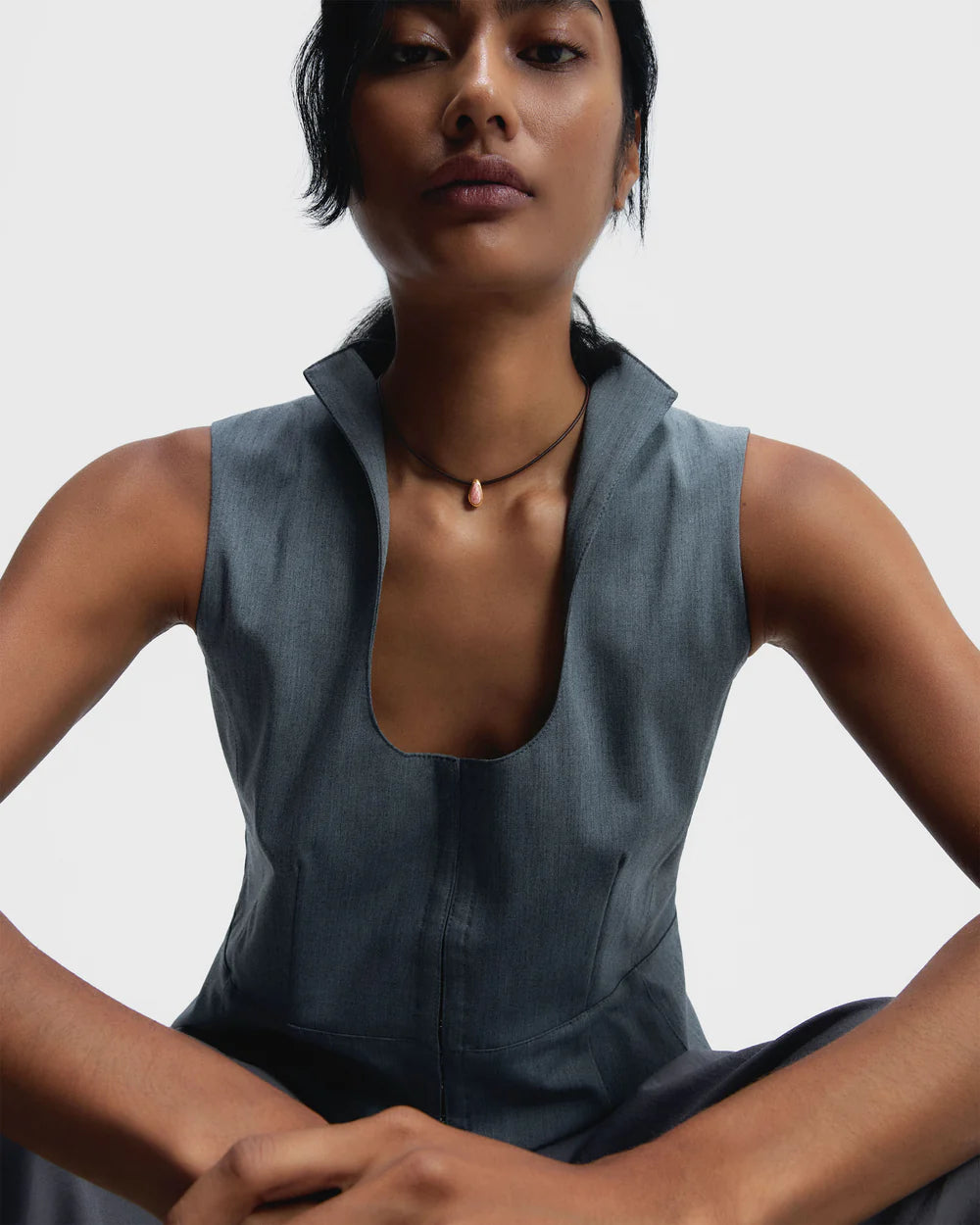 Woman wearing a sleeveless gray top and Rhodochrosite Luna Cord Necklace against a plain background