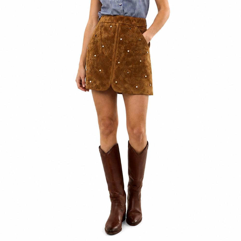 model wearing saddle mini skirt with gold studs and boots on a white background