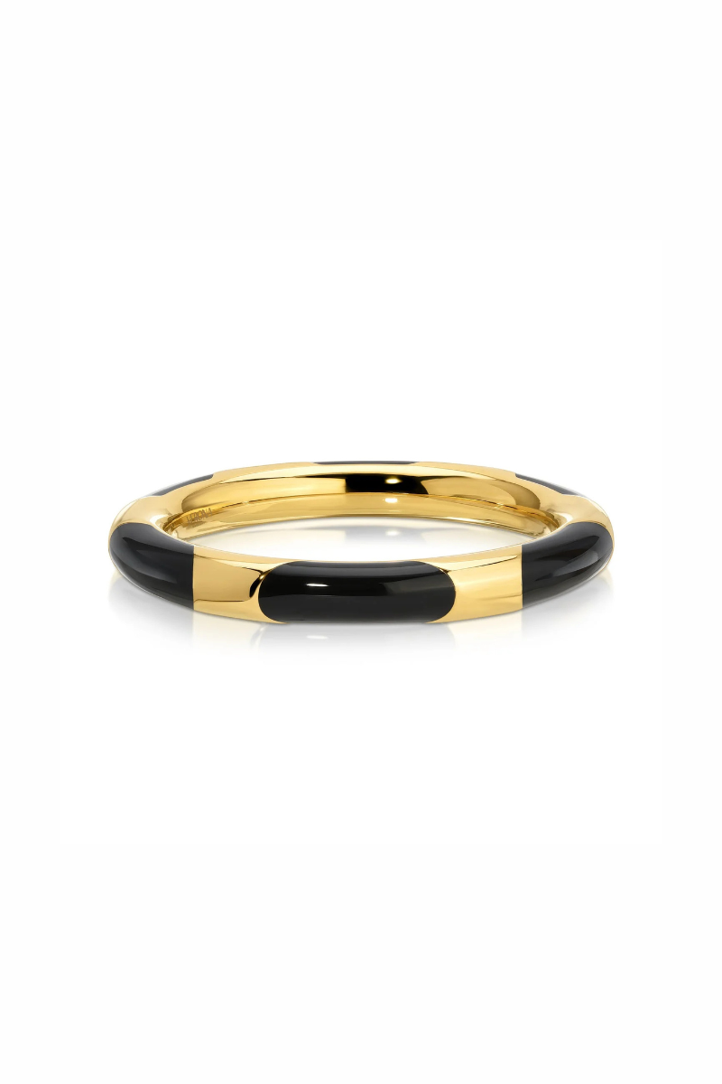 A gold-plated bangle bracelet with alternating black enamel segments, shown on a clean white background.