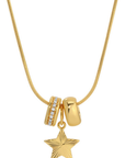 A gold necklace featuring three charms: a textured star pendant, a polished bead, and a spacer bead set with small clear stones, shown on a white background.