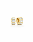 A pair of gold huggie hoop earrings with baguette-cut clear gemstones, shown on a plain white background.
