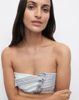 Woman wearing a strapless top and Tessa Necklace with a white background