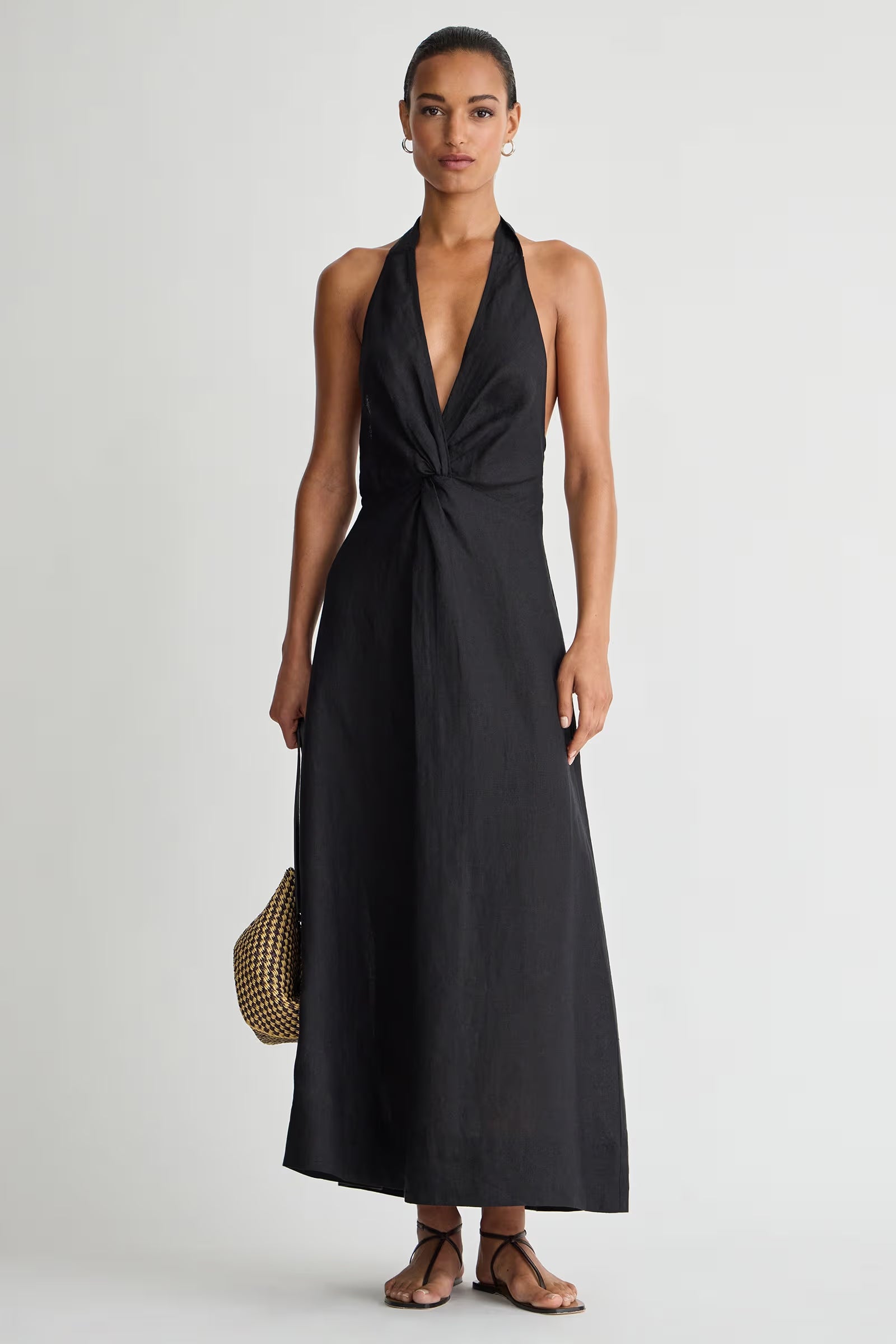 Woman wearing a black sleeveless dress on a white background