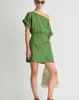 Woman wearing a green one-shoulder dress on a white background