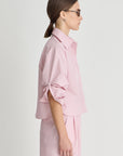 Woman wearing a pink outfit with a plain background