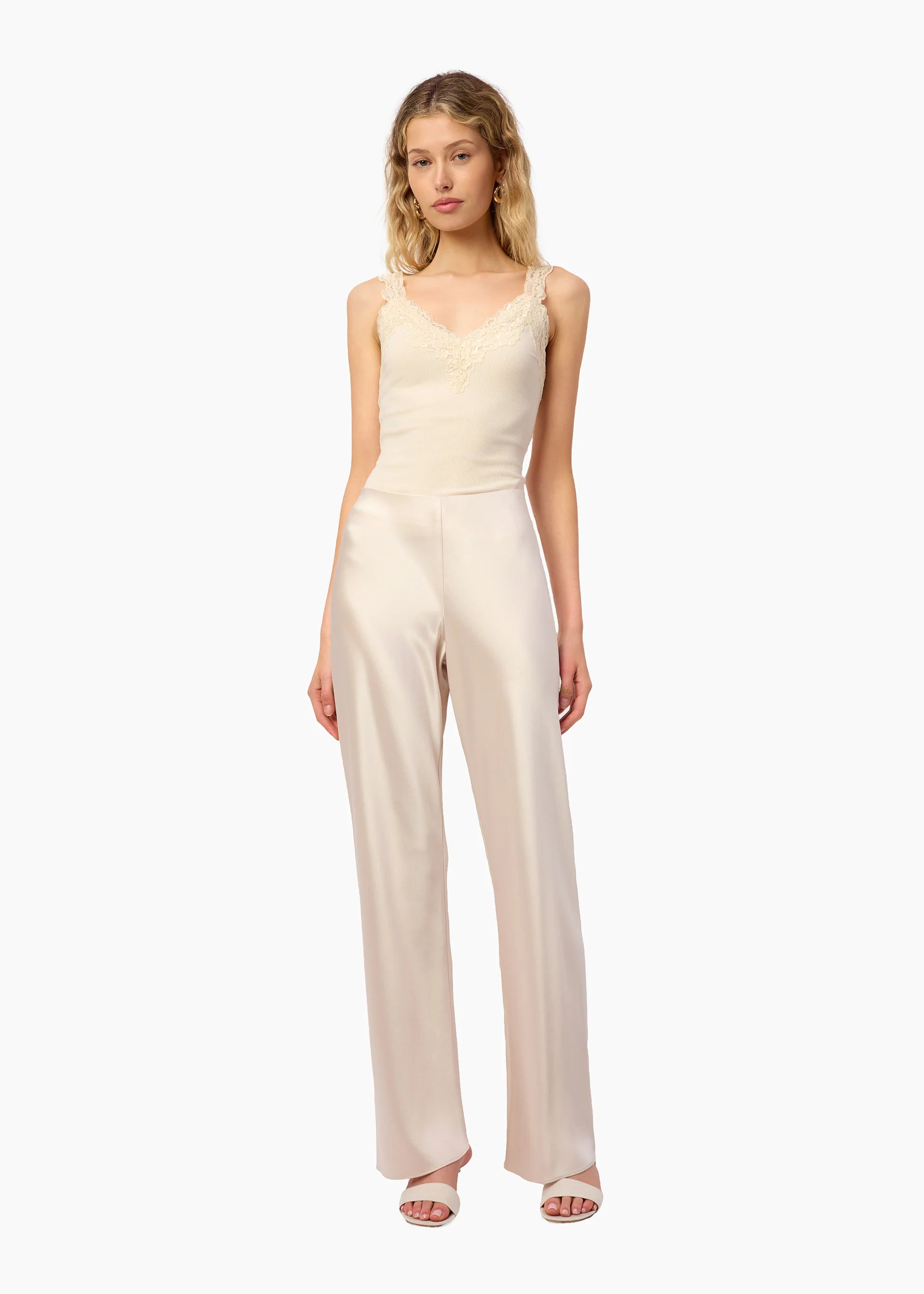 Woman wearing a beige jumpsuit on a white background