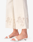 White sandals worn with white pants on a white background