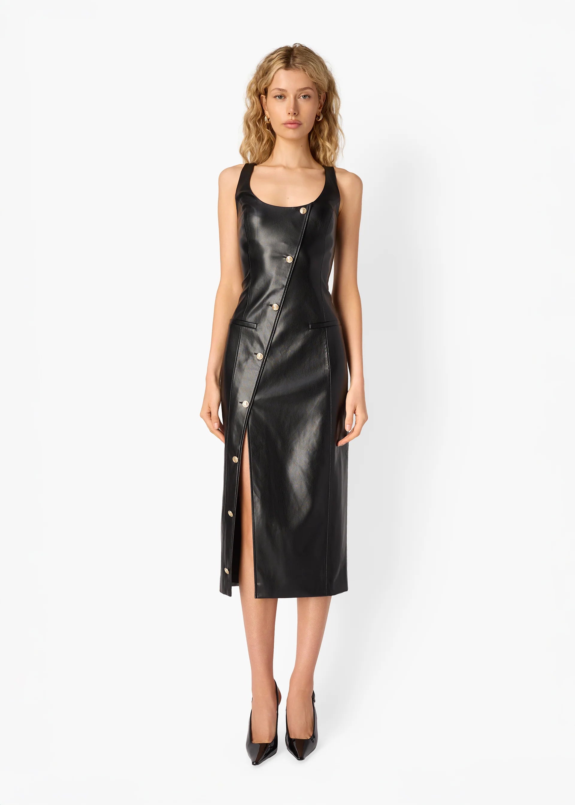 Woman wearing a black leather dress on a white background