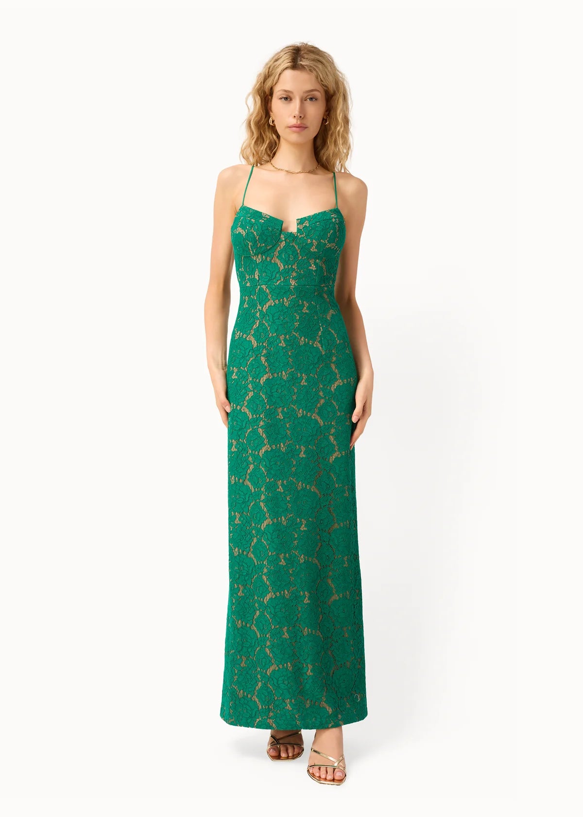 Woman wearing a green floral dress on a white background