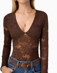 Brown lace long-sleeve top worn by a model on a white background