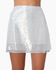 Silver sequin skirt worn by a person on a white background