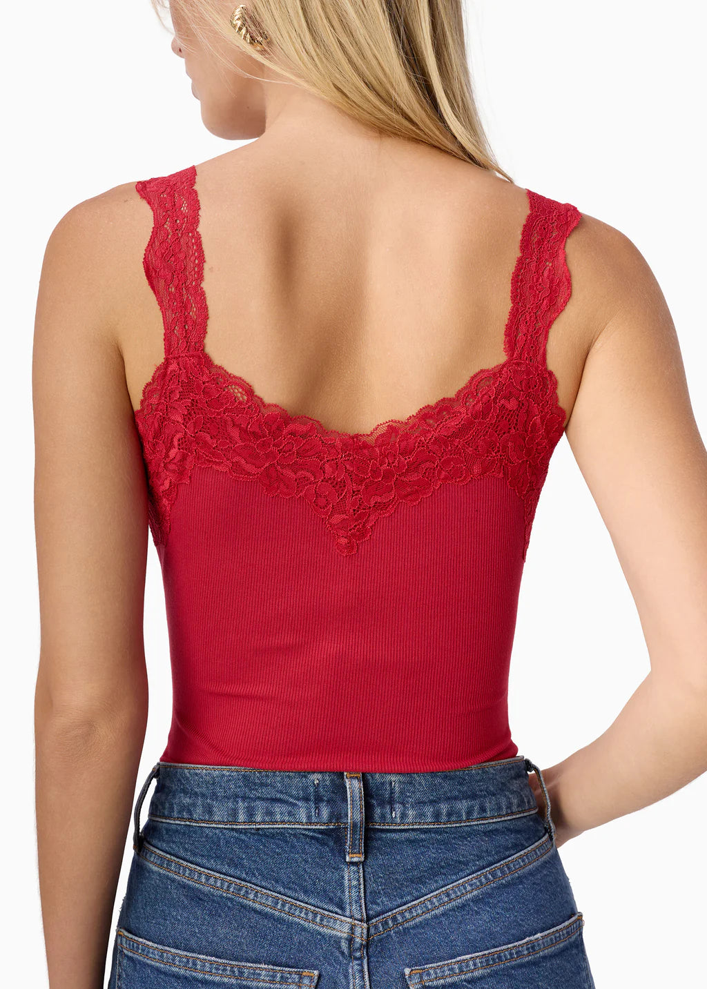 Red lace-trimmed tank top worn by a person on a white background