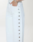 Light blue denim skirt with button details on a white background