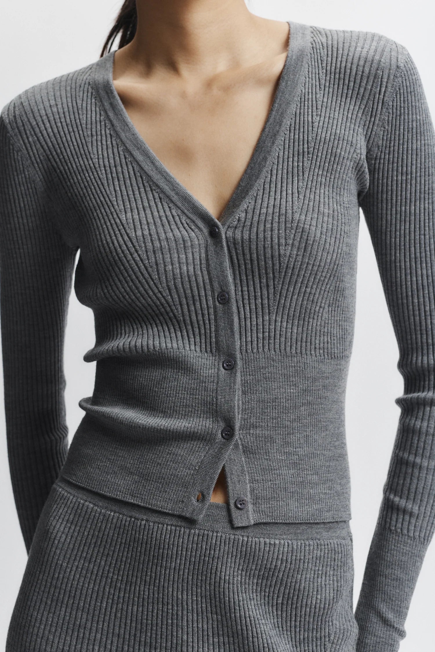 Gray ribbed sweater with buttons on a white background