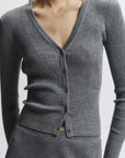 Gray ribbed sweater with buttons on a white background