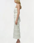 Woman wearing a white strapless set on a white background