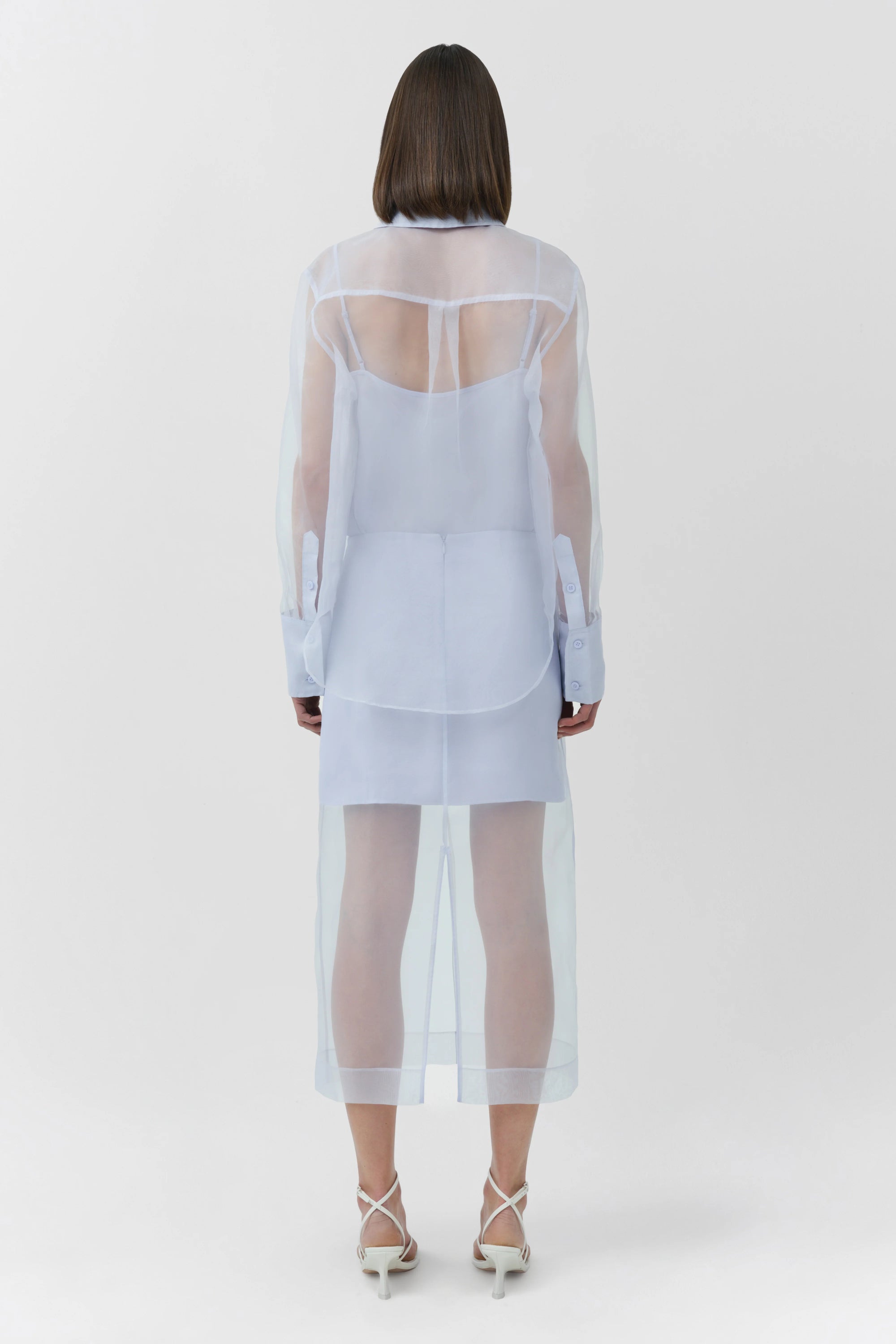 Person wearing a sheer blue outfit on a white background