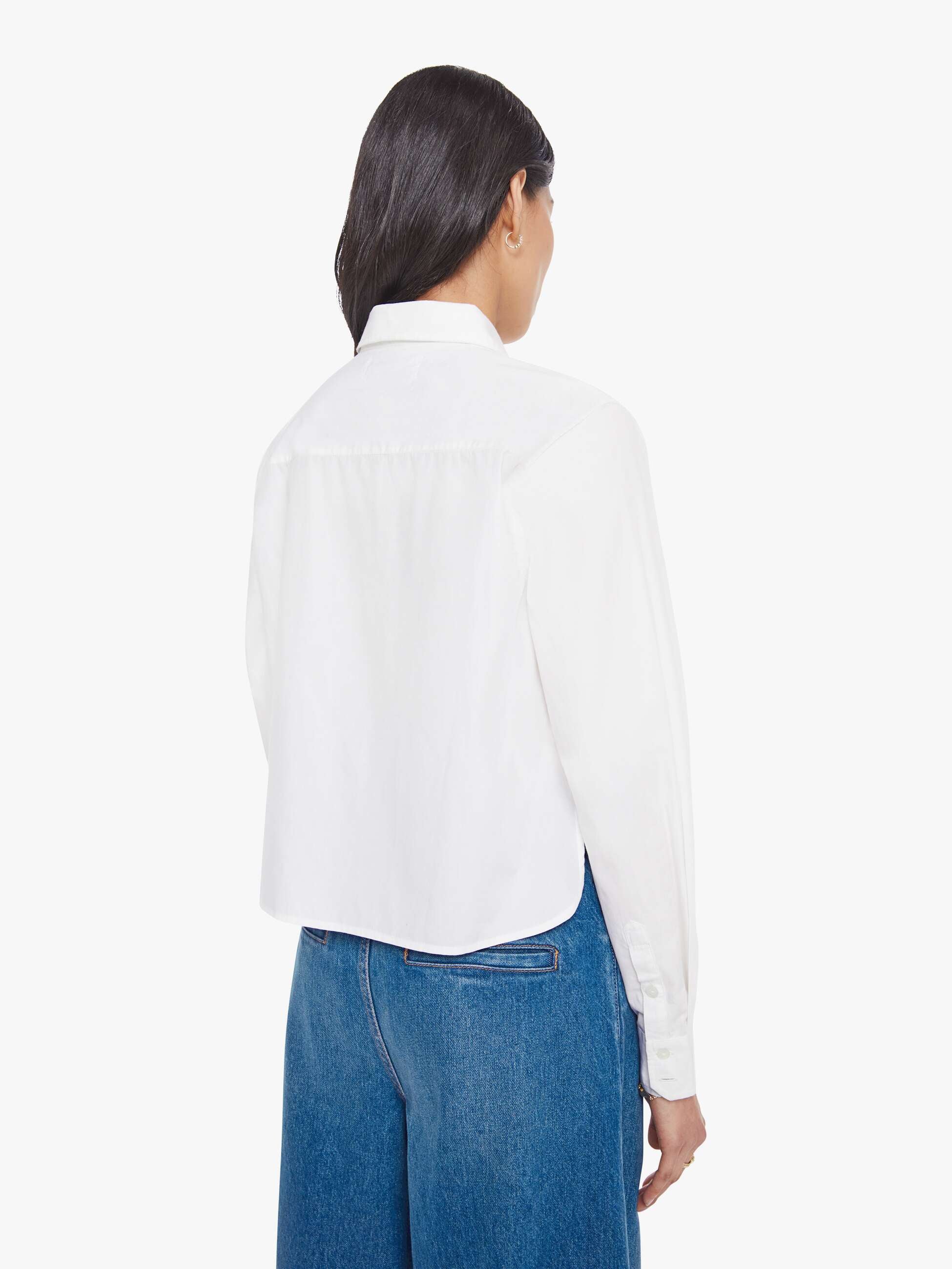Person wearing a white shirt and blue jeans on a white background