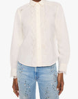 A model wearing a white long-sleeve button-up blouse with delicate lace trim down the front and on the shoulders, paired with light blue jeans featuring sequin embellishments, set against a plain white background.