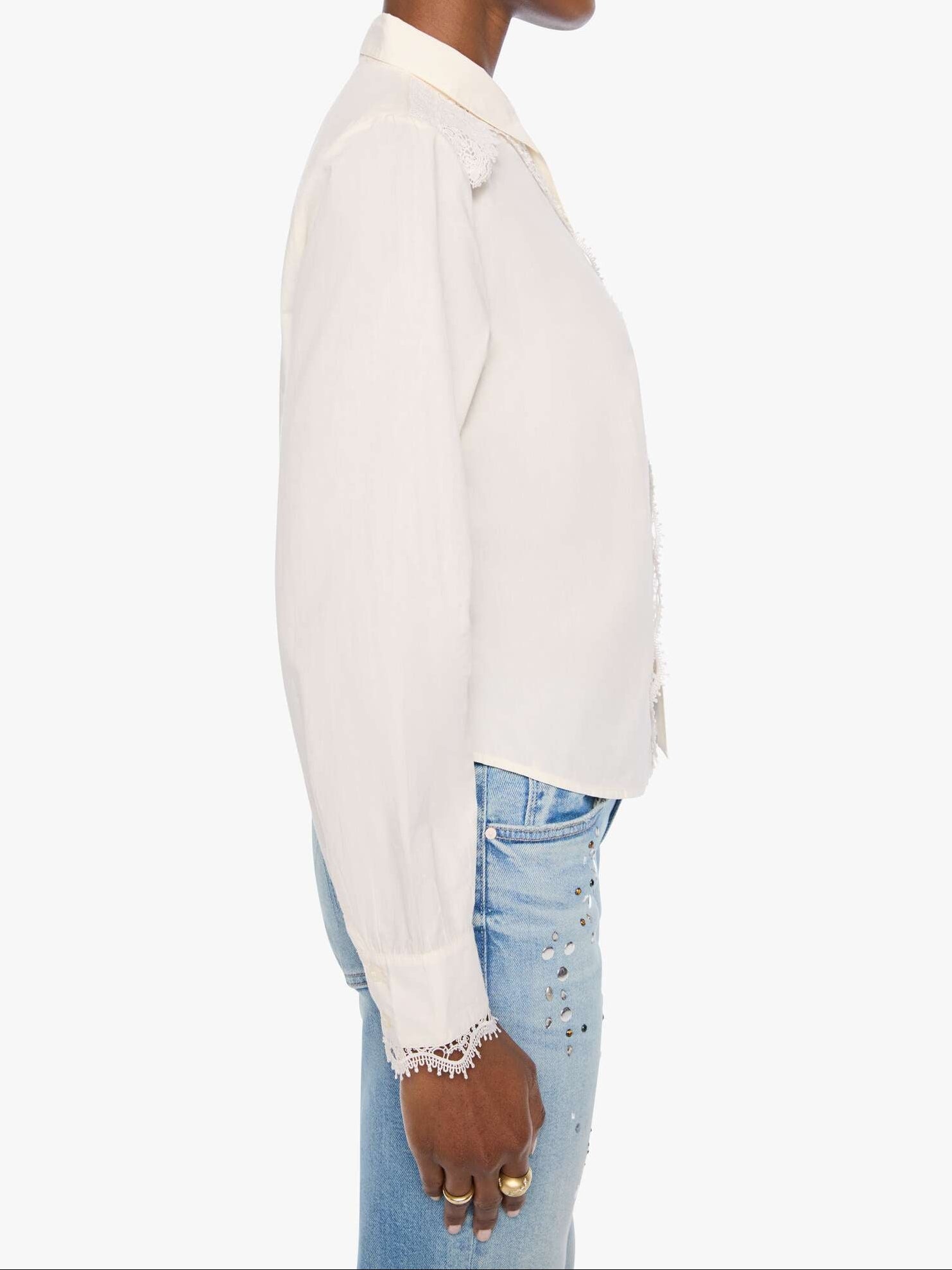 Person wearing a white blouse and blue jeans on a white background