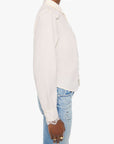 Person wearing a white blouse and blue jeans on a white background