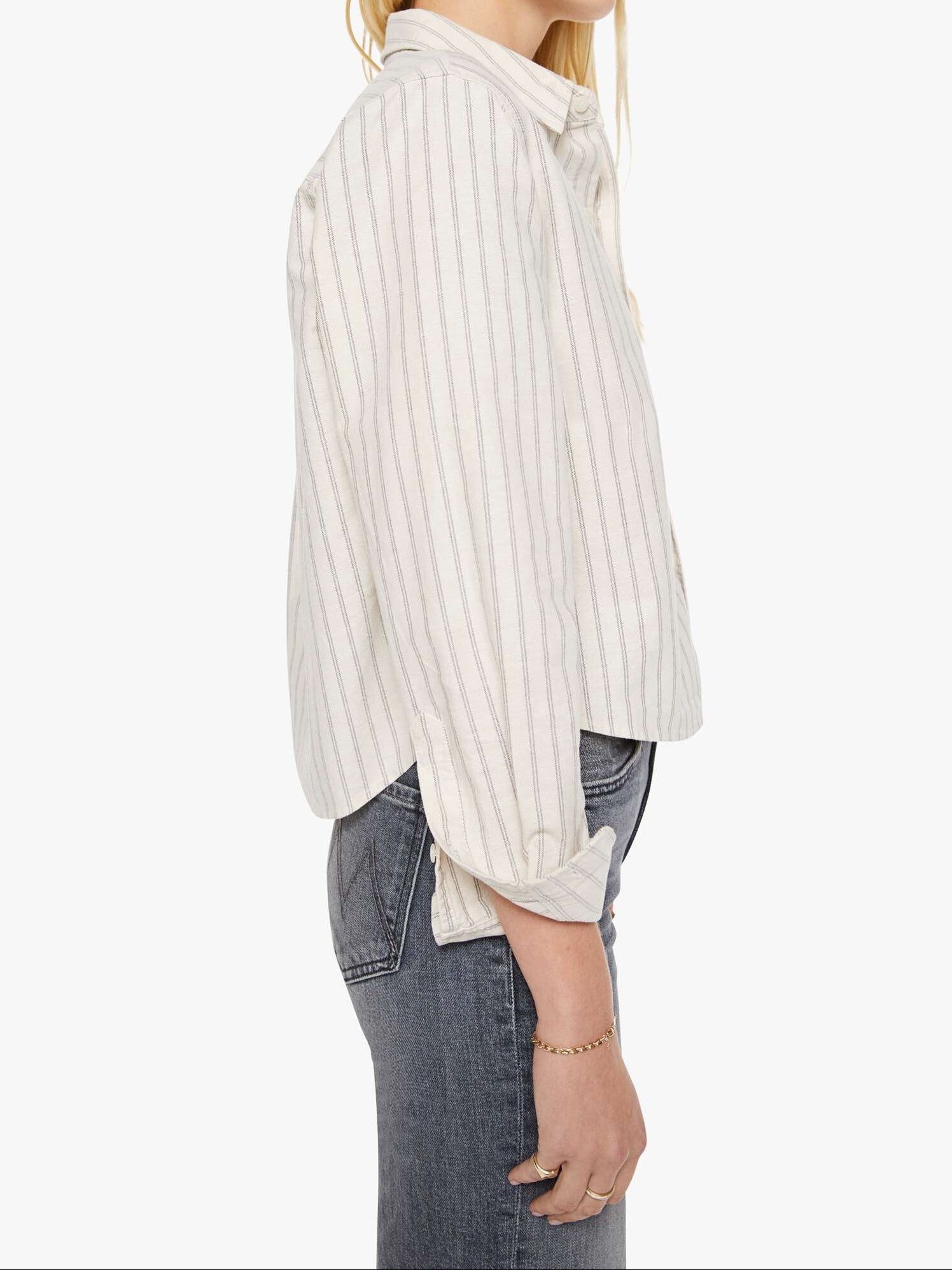 Woman wearing a white striped shirt and sunglasses on a white background