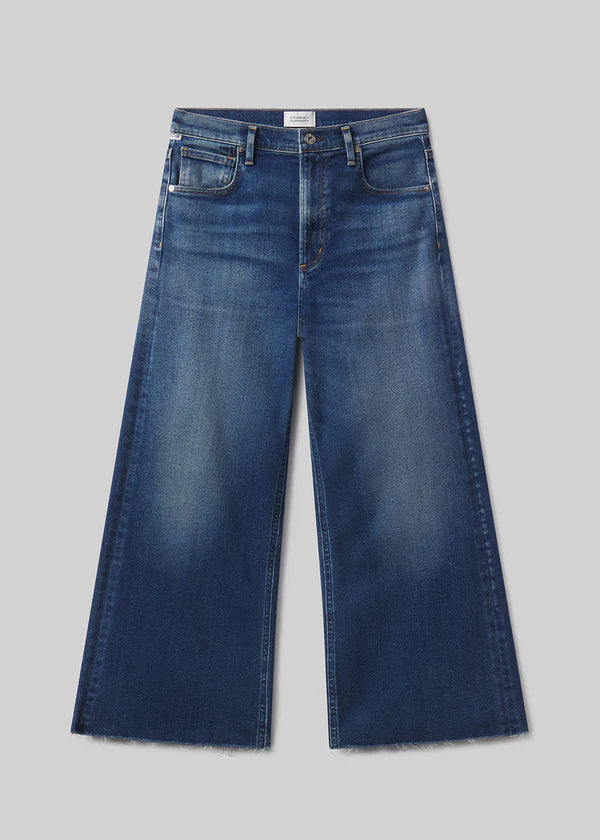 Pair of blue jeans on a light gray background