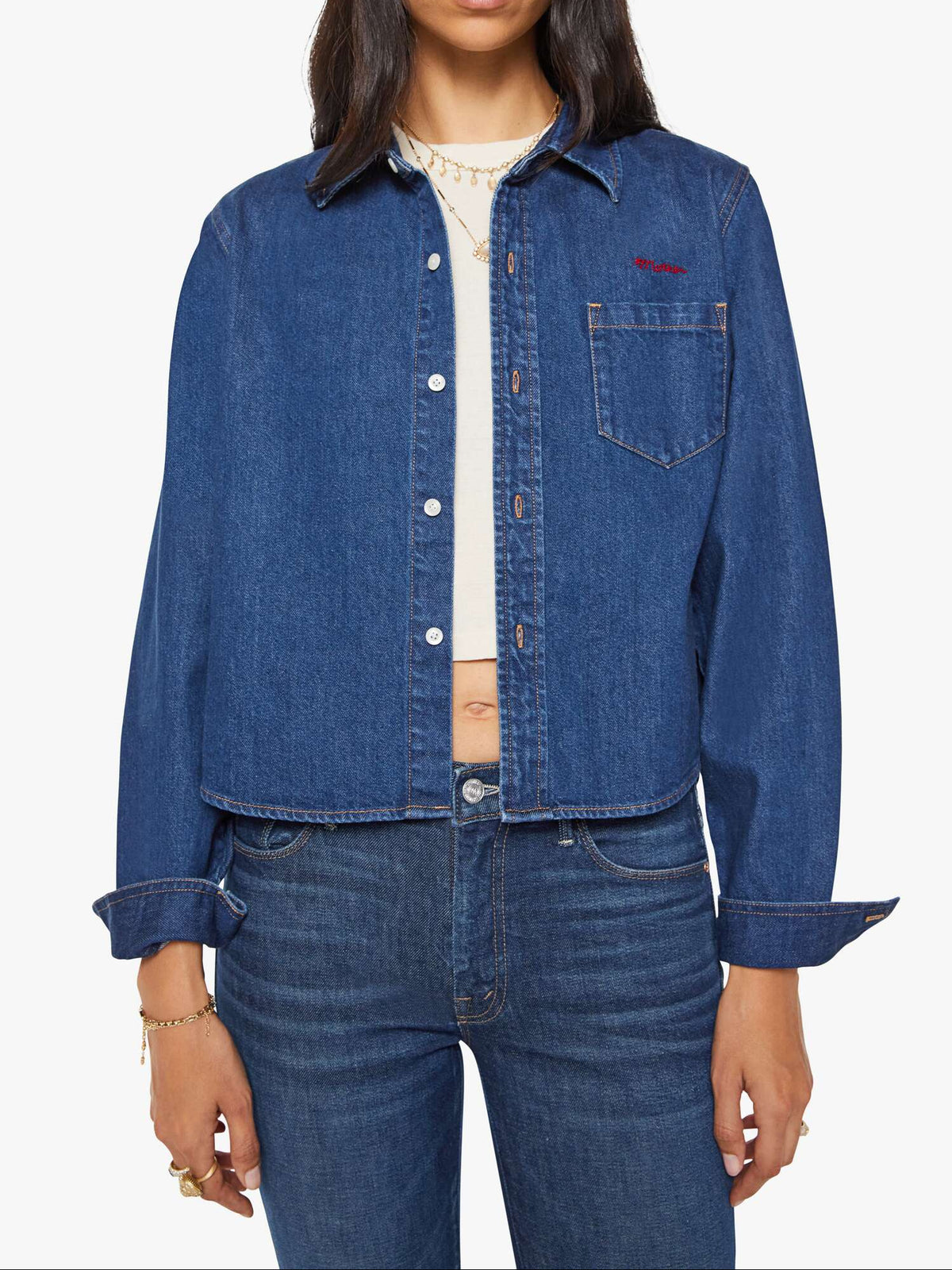 Woman wearing a blue denim jacket and jeans on a white background