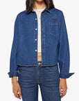 Woman wearing a blue denim jacket and jeans on a white background